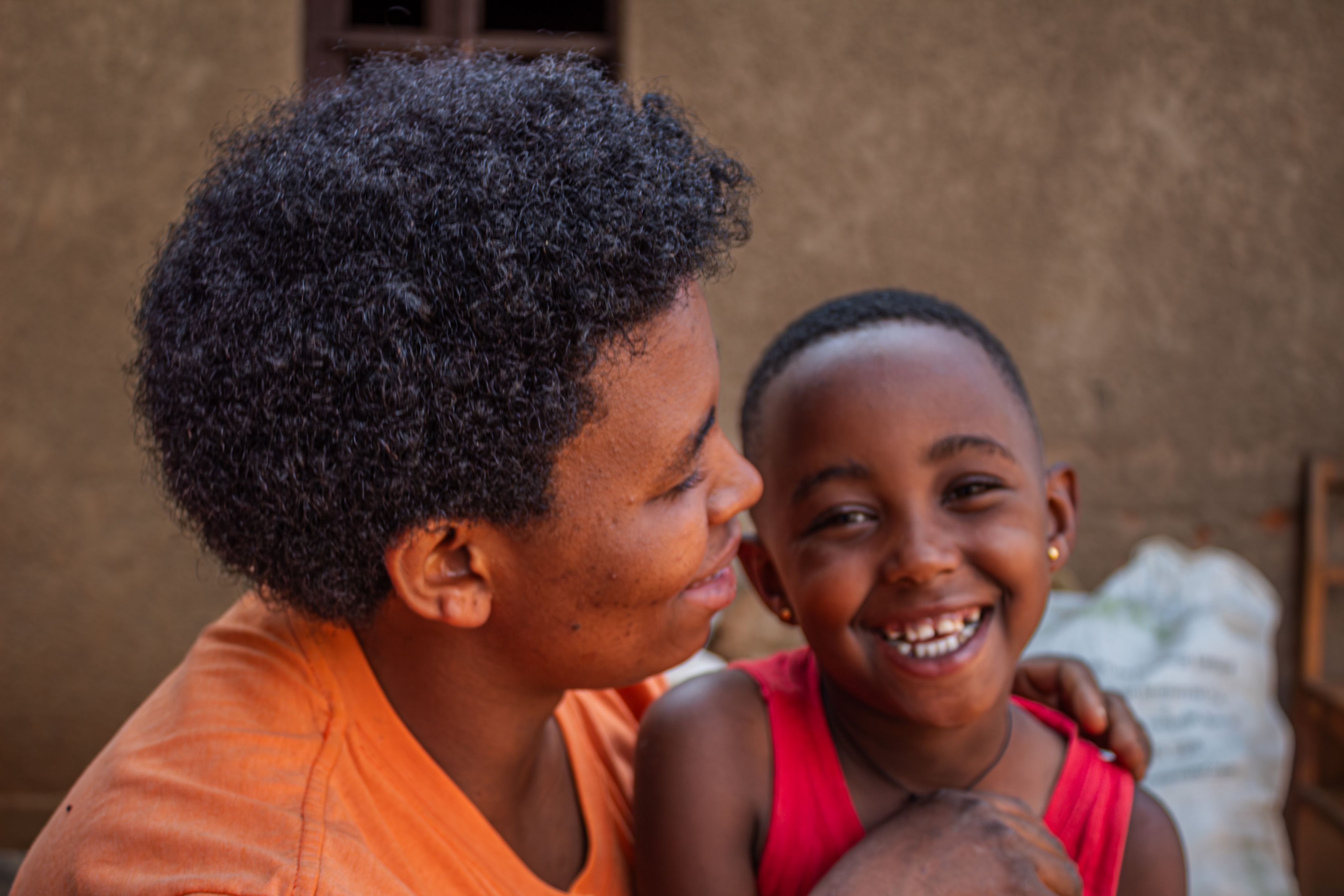 Celine plays with her youngest daughter outside their home in Gishali Rwamagana, on February 6 2024