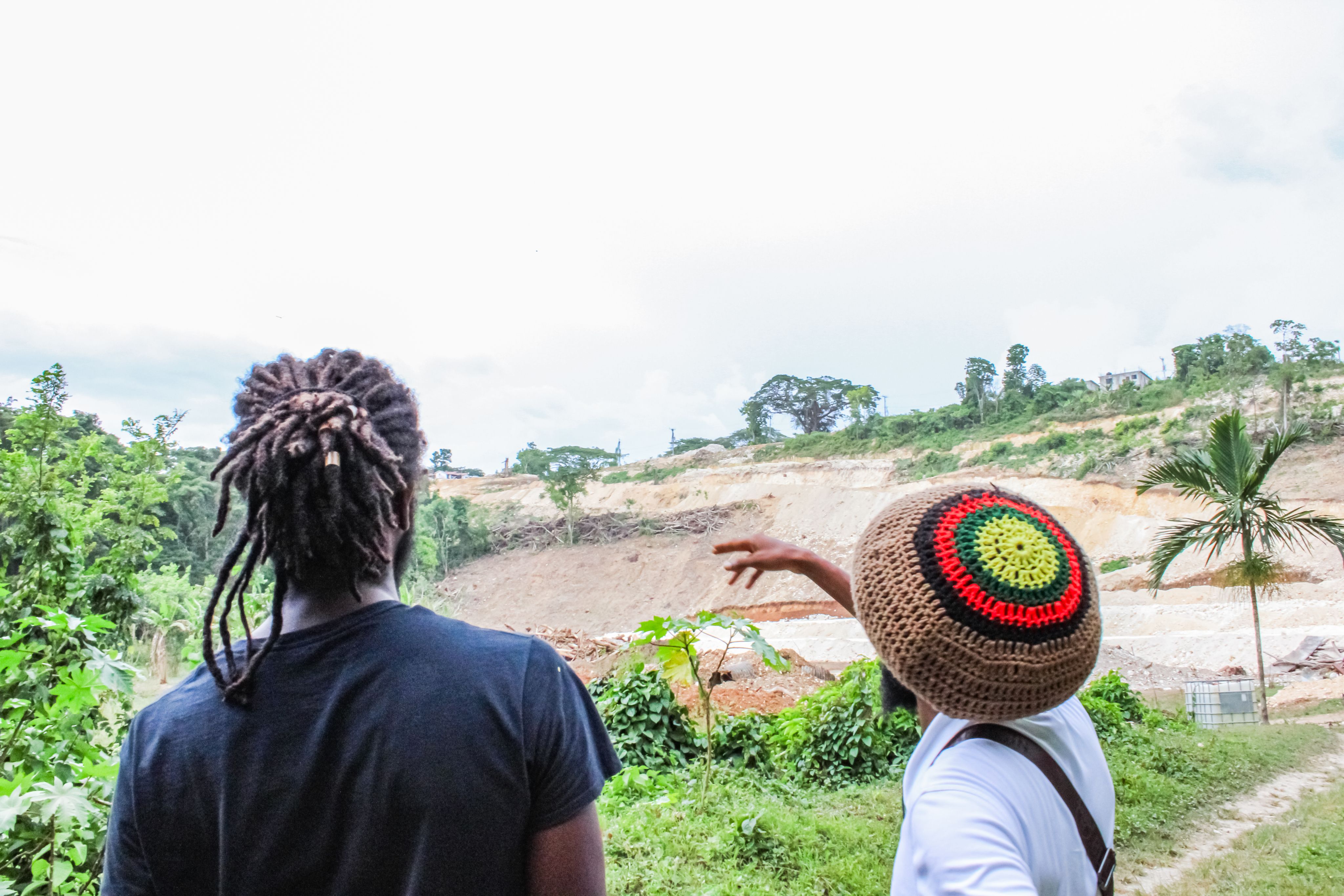 community members Iyan (left) and (right) show me the development of the new nearby highway, and its impact on the river and nearby community.